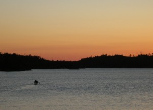 Wilderness rangers paddle down Ensign Lake in the BWCAW